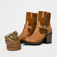 Fashionable brown leather boots paired with a matching belt in a studio shoot.